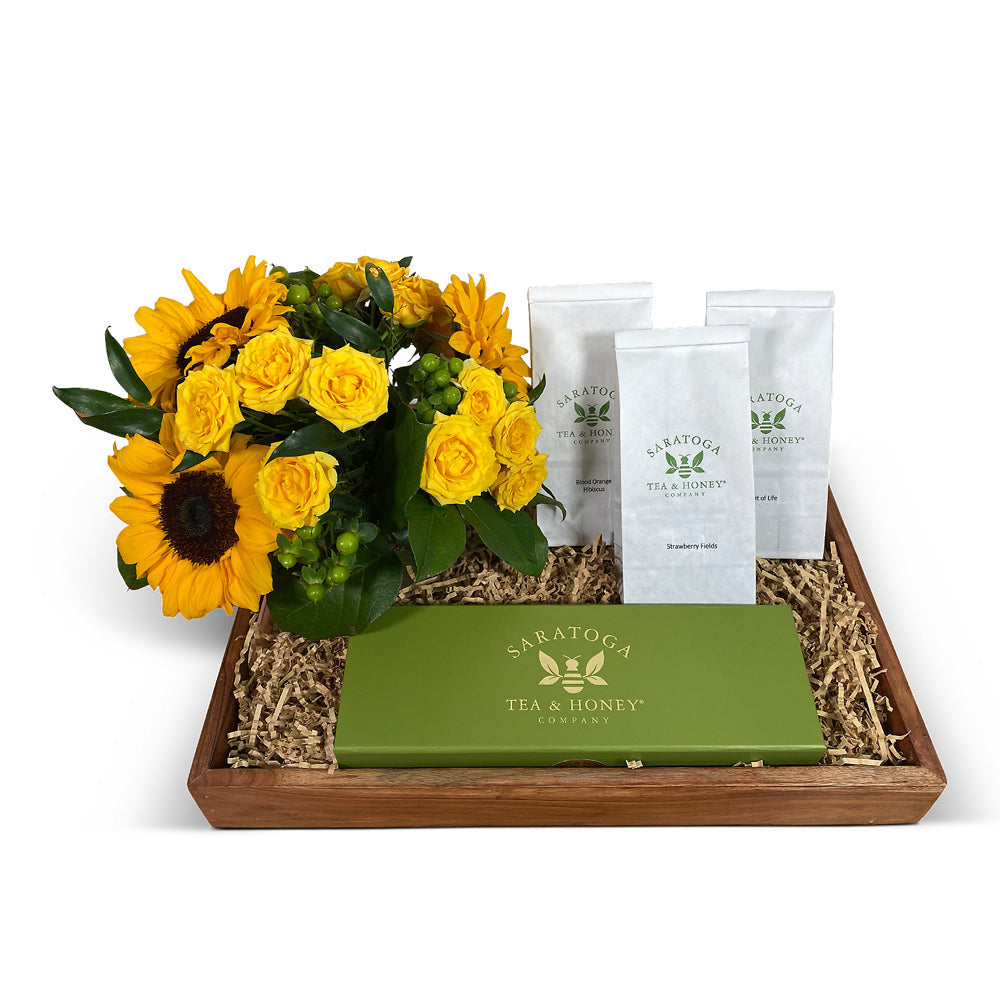 New baby gift basket with a small succulent, chocolates, and herbal tea
