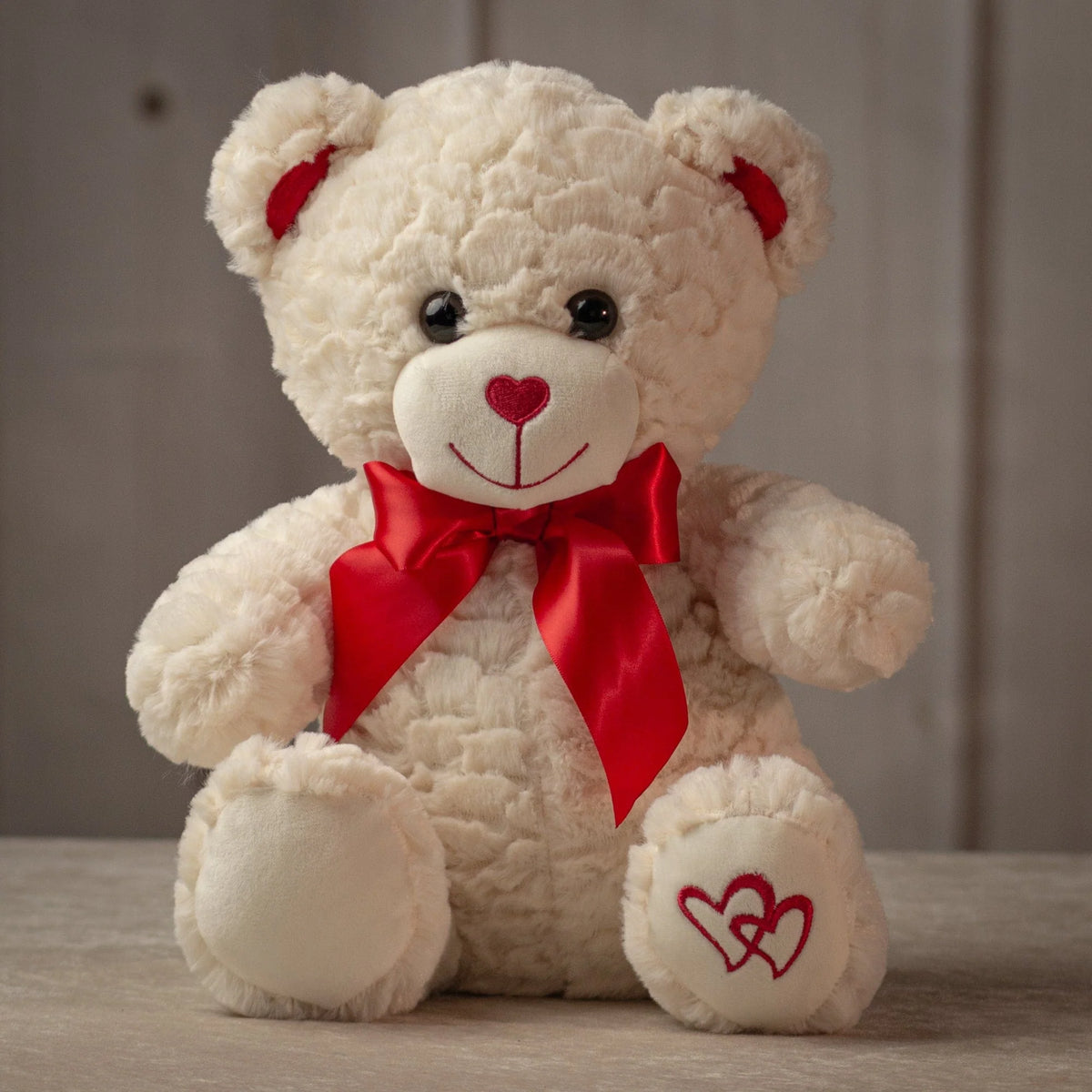 Ivory teddy bear with heart-shaped red nose and satin bow, Valentine's gift from Clifton Park florist
