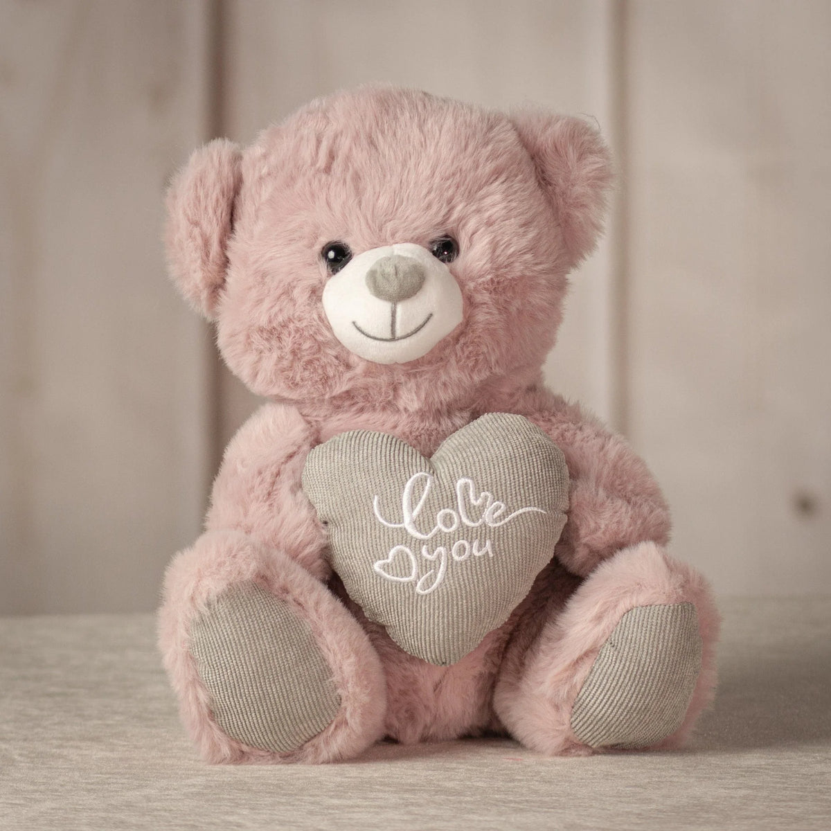 Dusty pink teddy bear holding gray heart with Kiss Me message, Valentine's gift from Clifton Park florist

